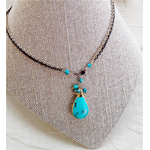Turquoise-pendant-on-gold-and-black-chain